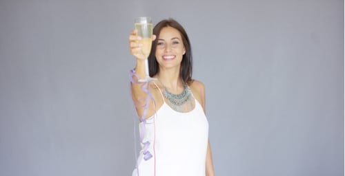 Cheerful Woman Celebrates with Champagne in Studio