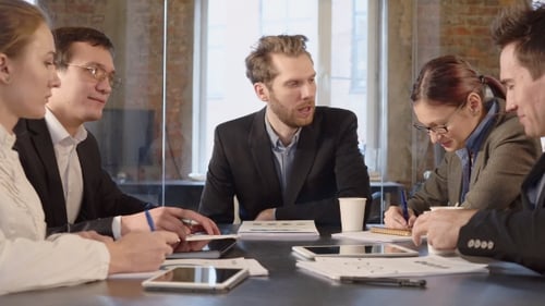 Diverse Team Discussing Business in Modern Office
