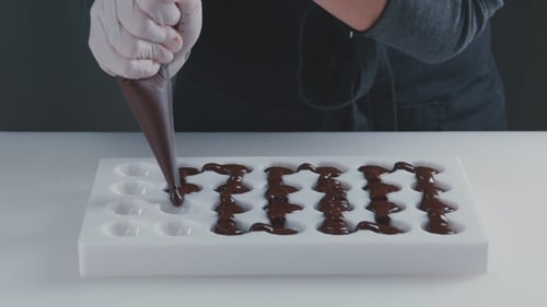 Crafting Chocolate: Filling Molds with Delicious Confectionary