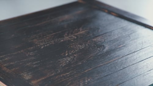 Hands Place White Chocolate Mold on Wooden Surface