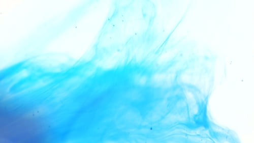 Abstract Turquoise Ink Swirling on White Background