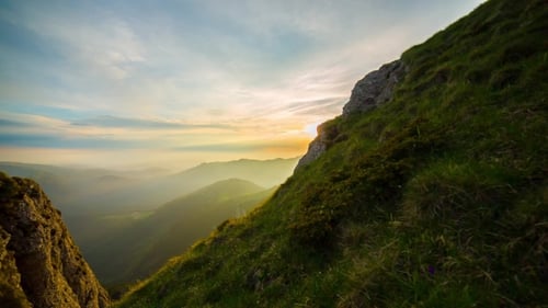 Mountains at Sunrise With Green Grass