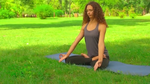 Young Caucasian Girl Trains Yoga Outdoor