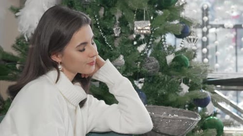 Woman Smiling Near Christmas Tree During the Day