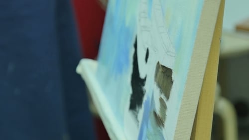 Artist Painting on Canvas with Brush in Home