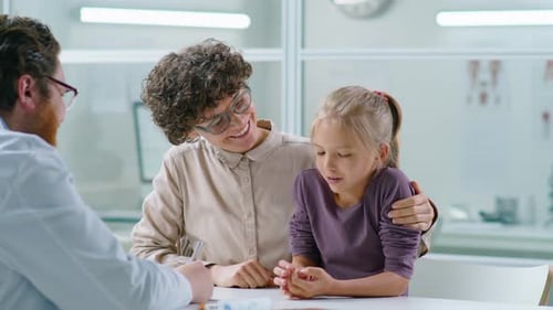 Mother and Little Daughter Having Consultation with Pediatrician