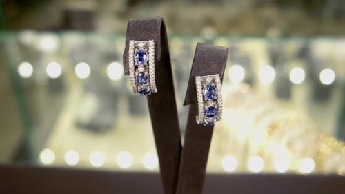 Jewelry, Women Earrings In Gold With Blue Gems Earrings With Diamonds On In Storefront At a Jewelry
