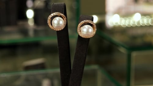 Elegant Gold and Pearl Earrings on Display