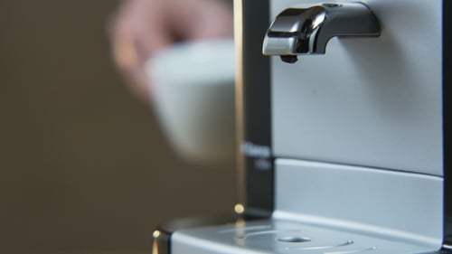 Coffee Machine Dispenses a Hot Beverage Into Mug