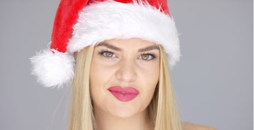 Festive Woman in Santa Hat Smiling at Camera