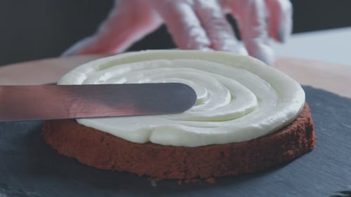 Pastry Chef Frosts Delicious Red Velvet Cake