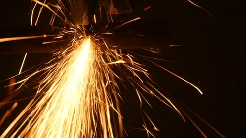 Construction Worker Using An Angle Grinder