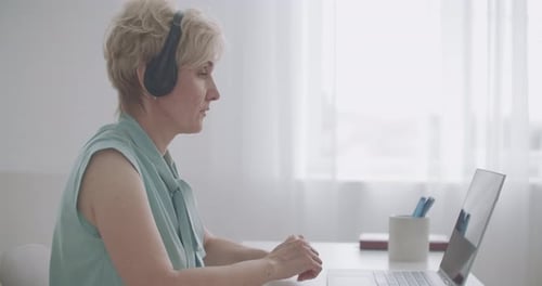 Woman in Video Call at Desk Indoors