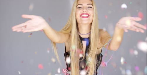 Blonde Woman Celebrates with Confetti and Ribbons