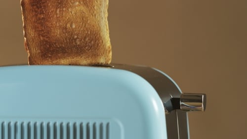 Two Loaves Of Bread Jumping Out Of An Electric Toaster
