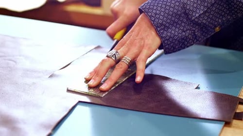 Hands Cutting Leather with Blade and Ruler