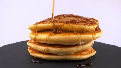 Golden Pancakes Stack Drizzled with Sweet Syrup