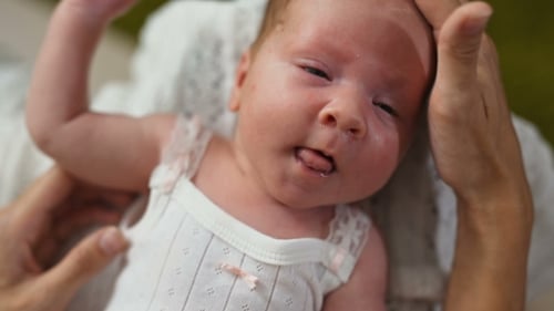 Serene Infant Cared For by Loving Adult