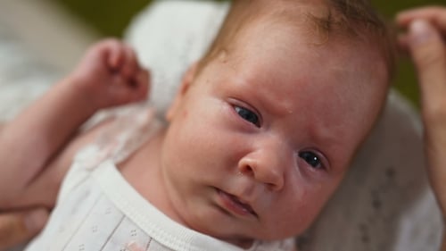 Close Up of Newborn Baby with Gentle Hand