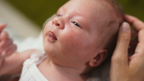 Close Up of Crying Newborn Baby Being Held