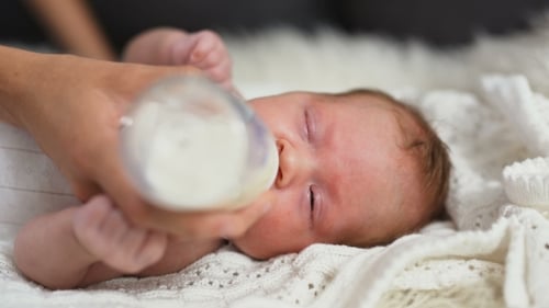 Bottle Feeding a Baby at Home on Blanket