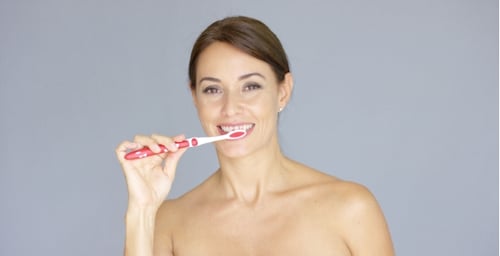 Attractive Woman Brushing Teeth with a Toothbrush