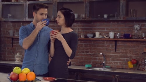 Affectionate Couple Enjoying Coffee Together in Kitchen