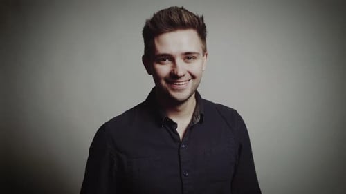 Handsome Man Posing in Front of White Wall