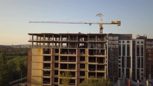 Aerial view of tall residential apartment buildings under construction.