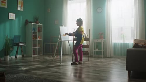 Girl with Arm Sling Painting at Easel