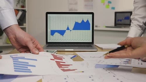 Team Analyzing Business Data in Bright Office