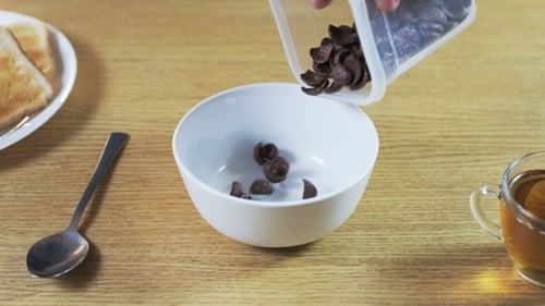 Pouring Chocolate Cereal in the Morning