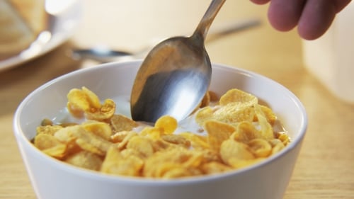 Corn Flakes Cereal Being Mixed With Spoon