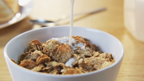 Milk Being Poured on Cereal Flakes in Bowl