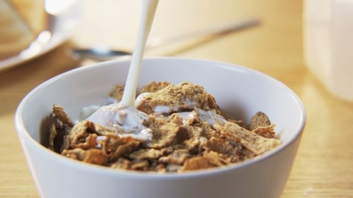 Milk Pouring onto Cereal Flakes for Tasty Breakfast