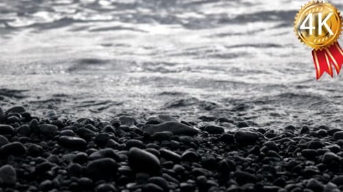 Waves Rolling in on a Pebble Coast Line With