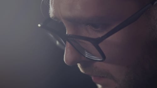 Man In Black Rim Glasses Using His Computer In Office