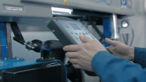 A Man Standing Near The Control Panel.