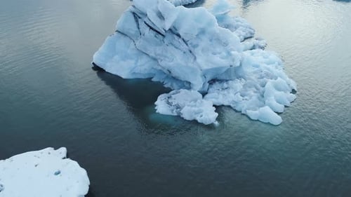 Glacier Icebergs Floating And Melting On Ocean