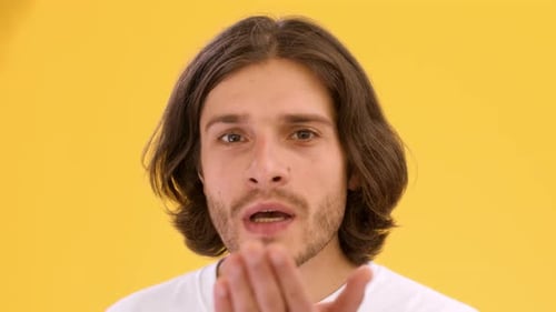 Young Man Blowing a Kiss in Studio