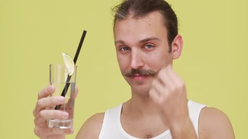 Man Sipping Refreshing Drink with a Straw, Close Up