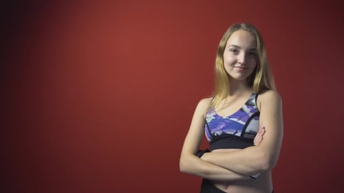Athletic Woman Smiling with Arms Crossed
