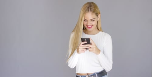 Trendy Young Blond Woman Checking Her Mobile