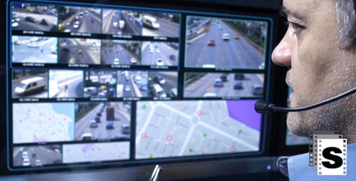 Man Monitors Traffic Camera Footage on Computer Screen