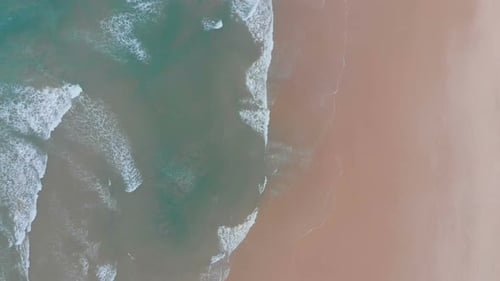 Aerial View of Sea Waves Break on Yellow Sand Beach