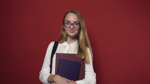 Young Female Student Smiling Holding Books