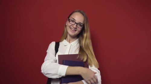 Smiling Student With Books Poses Confidently