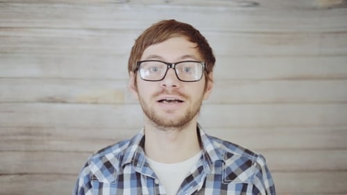 Young Adult Man Talking and Gesturing Indoors