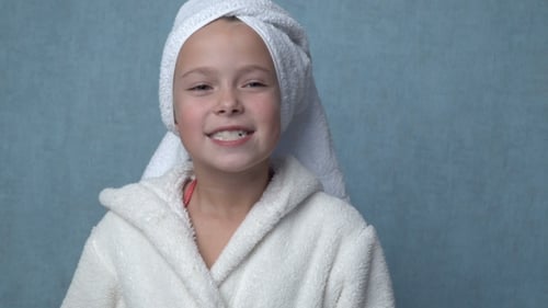 Young Girl Brushing Teeth With Electric Toothbrush