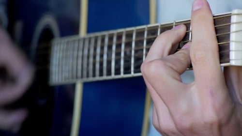 Hands Playing Guitar Close-Up on Frets and Strings